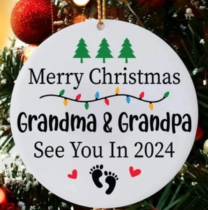 Merry Christmas Grandma and Grandpa 2024 ceramic ornament hanging on a festive tree