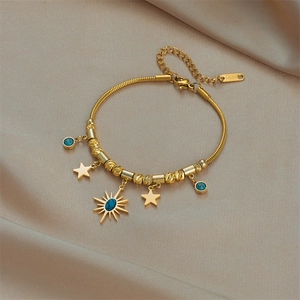 Gold stainless steel bracelet with star pendants and blue turquoise beads on silk