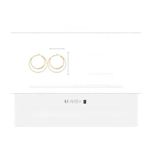 Detail view of 18k gold plated copper triple layered hoop earrings with silver needles