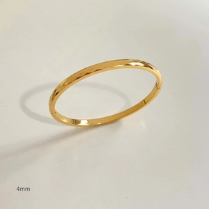 Detailed close-up of 4mm gold plated stainless steel bracelet with geometric patterns