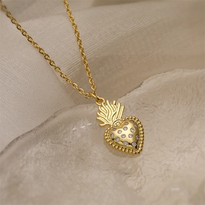 Macro shot of gold-plated heart pendant necklace with shimmering zircon stones