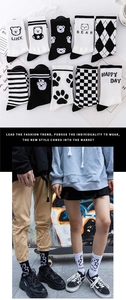 Detail of assorted black and white cotton crew socks with bear patterns and checkerboard designs