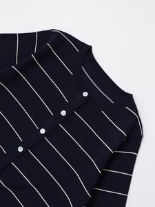 Close-up of dark blue knitted cardigan with white stripes and elegant button detail