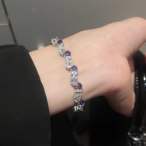 Detail of silver twisted bracelet with purple and white zircon stones on wrist