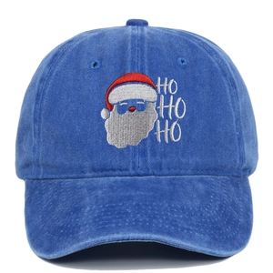Detail of Santa embroidery with HO HO HO text on washed blue cotton baseball cap