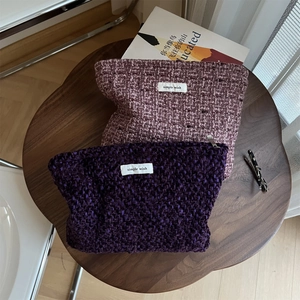 Chic tweed woven makeup bags in purple and pink tones with simple wish label on a table