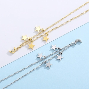 Macro detail of gold and silver star and moon necklaces with crystal pendants