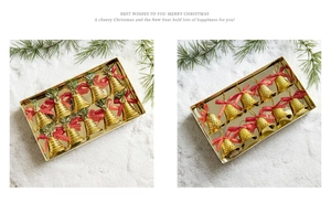 Close-up of 12 gold Christmas bells with red polka dot ribbons in clear packaging
