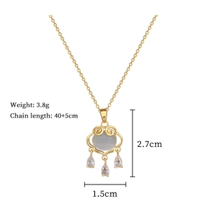 Detail of gold cat-eye stone lock necklace with cubic zirconia pendants and dimensions