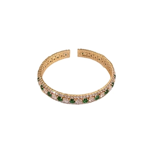 Elegant gold open bangle with emerald-cut green gems and sparkling zircon stones