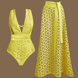 Flat lay of yellow cutout swimsuit and matching lace cover-up skirt set for beachwear