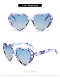 Detail of heart-shaped sunglasses in flower blue with blue gradient lenses