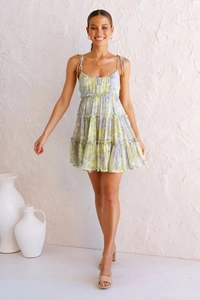 Detail of yellow-green floral tiered dress with spaghetti straps and layered ruffle design