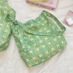 Detail of floral tote bag made of natural cotton linen with green flower print