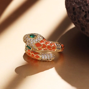 Adjustable snake ring in gold brass with orange enamel and sparkling zircons