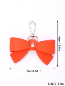 Orange leather bow bag charm with silver clip and rhinestone, 9cm size and 15.5g weight