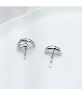 Macro view of silver-tone polished irregular curved metal hair hook hairpiece