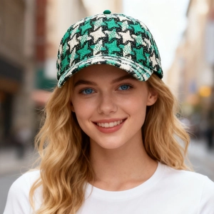 Stylish green and black houndstooth baseball cap shown on model in urban setting