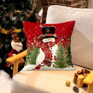 Christmas snowman cushion cover on sofa with festive tree and linen texture