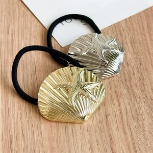 Minimalist gold and silver seashell hair ties with starfish relief on elastic bands