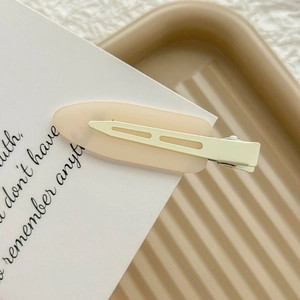 Matte rainbow seamless hair clip in light orange for women with a minimalist metal base