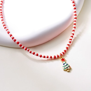Detail of beaded Christmas necklace with a gold enamel Christmas tree pendant and rhinestones