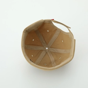 Internal view of khaki skull cap showing reinforced seams and adjustable metal buckle