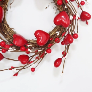 Close-up of Valentine's day heart wreath with red berries and natural rattan texture
