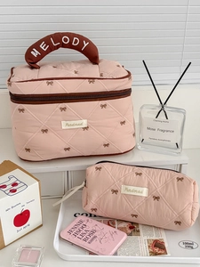 Pink quilted makeup bag set with cute bow embroidery and convenient carry handle