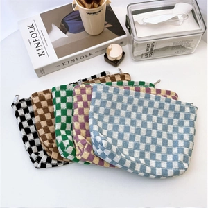 Detailed collection of colorful knitted checkerboard makeup bags with secure zippers