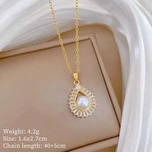 Close-up of teardrop pearl pendant with diamond halo on a golden chain