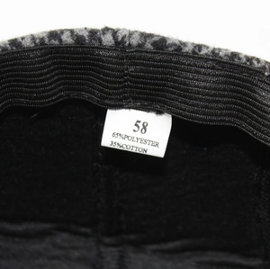 Gros plan de l'étiquette d'un béret montrant la taille 58 et le mélange coton-polyester