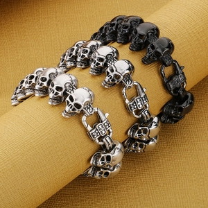 Detailed view of punk skull bracelets in vintage silver and matte black finishes
