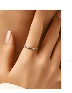 Detail of S925 sterling silver ring with blue gems and white diamonds on female finger