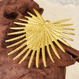 Golden 304 stainless steel sunburst pendant with dotted texture on natural wood base