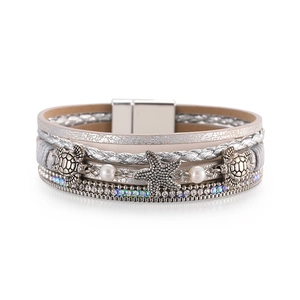 Exotic holiday wrap bracelet featuring silver starfish, turtle charms and crystals
