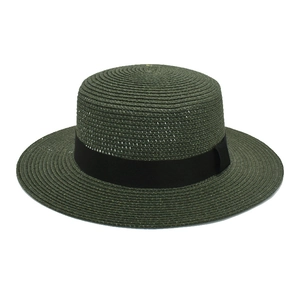 Detail of dark green straw boater hat with flat brim and elegant black ribbon band