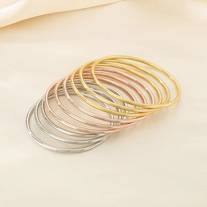 Set of three stackable 3mm stainless steel round bangles in gold, silver and rose gold