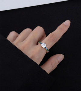 Macro detail of vintage gold ring with square main stone and colorful side gemstones
