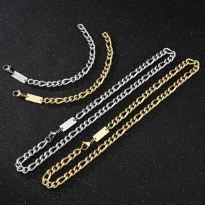 Flat lay of gold and silver titanium steel necklaces and bracelets with rectangular tags