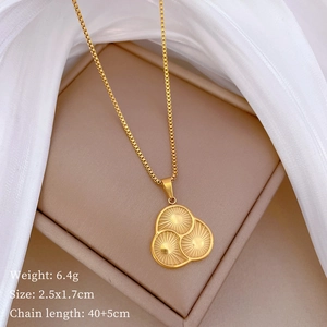 Macro view of gold titanium steel four-leaf clover pendant with radial texture detail