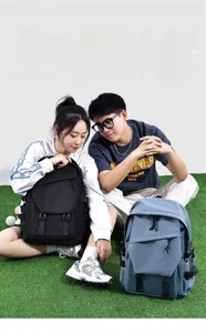 Workwear style backpack with multi-pocket design shown in black and grey-blue colors