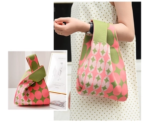 Macro detail of a knit knot bag with pink and olive green diamond geometric patterns