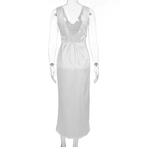 Detail of white silk nightdress featuring low back V-neckline and delicate lace trim