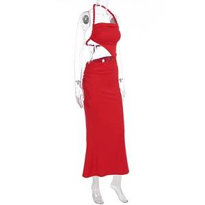 Detail of red halter neck dress featuring lateral waist cutout and gathered ruched fabric