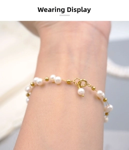 Detailed close-up of handmade freshwater pearl bracelet with gold beads on a wrist
