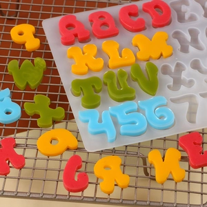 Silicone alphabet mold with colorful resin letters and numbers on a cooling rack