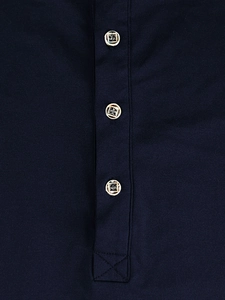 Macro shot of navy blue knit hoodie featuring button placket and decorative textured buttons