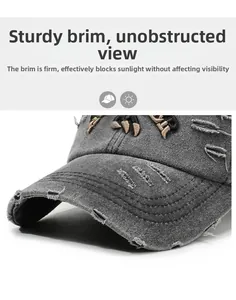 Detailed macro view of gray distressed baseball cap brim with worn edges and claw embroidery