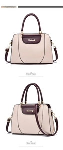 Detailed view of bicolor beige and burgundy handbag with gold chain buckle and logo